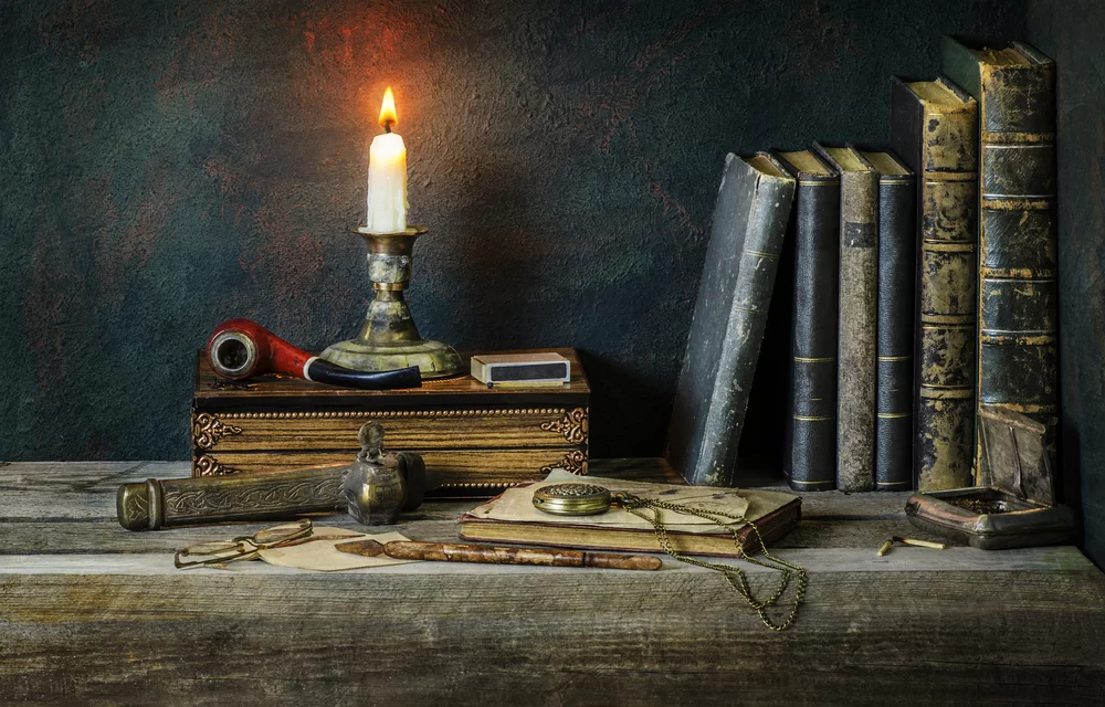Classic,Still,Life,With,Vintage,Books,Placed,With,Illuminated,Candle,old